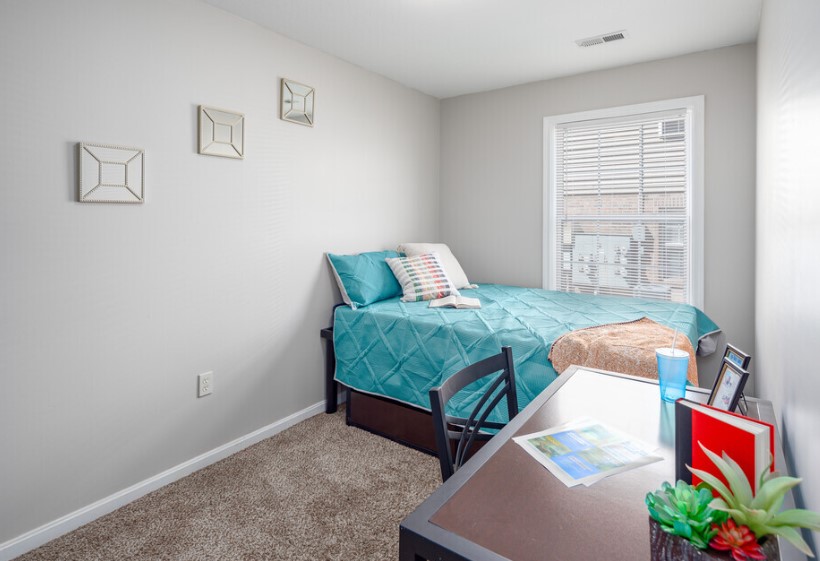 a bedroom with a bed and a table