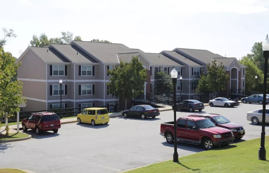 a parking lot with cars parked in front of a building