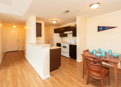 a kitchen and dining area with wood floors