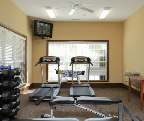 a room with treadmills and a tv
