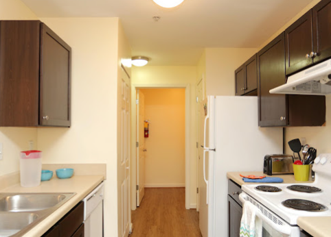 a kitchen with white appliances and cabinets