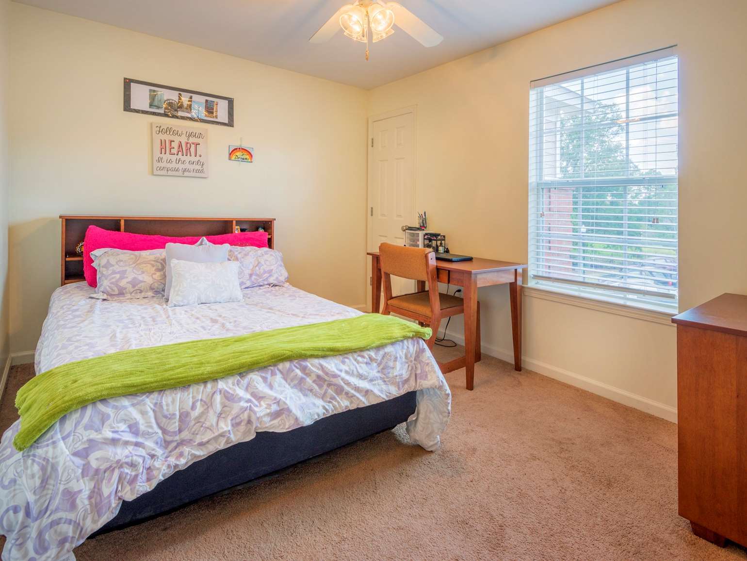 a bedroom with a bed and desk